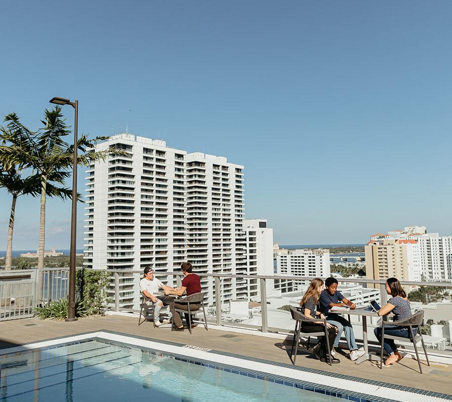 community development students sitting at tables on the rooftop of a building