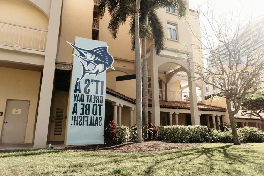 a sign saying "its a great day to be a sailfish" in front of a PBA building