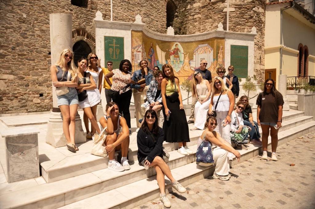 a group of students on an an experiential learning trip to turkey standing on steps and smiling